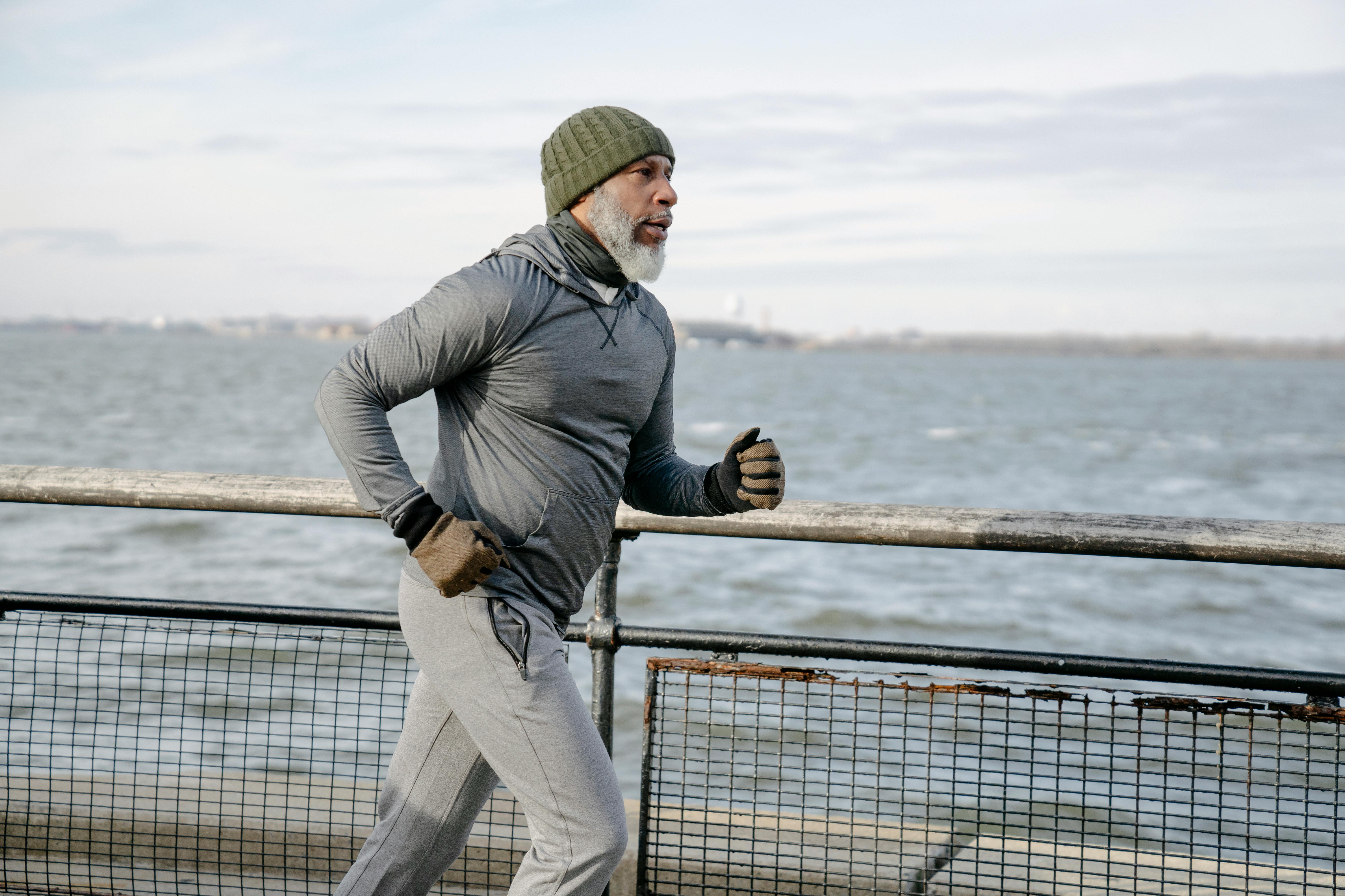 Jeff Smith running along a fence, overlooking a lake